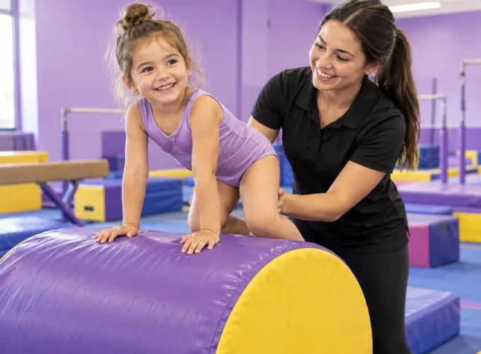 A preschool gymnast learning with a coach
